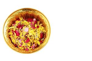 Red rose and Marigold flowers petals in gold tray isolated on white background in tradition Thai wedding ceremony and Buddhism in the temple photo