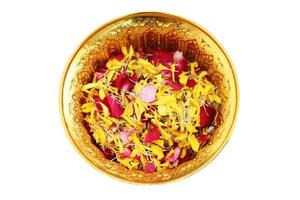 Red rose and Marigold flowers petals in gold tray isolated on white background in tradition Thai wedding ceremony and Buddhism in the temple photo