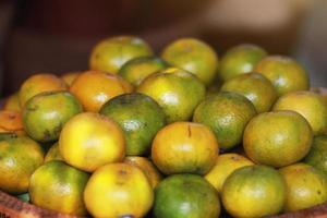 Fresh orange on banana leaves in wicker food tray. Thai buffet food tradition in event and wedding ceremony photo