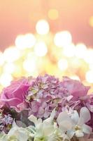 Beautiful blooming flowers on bokeh of candle light background in wedding ceremony. photo