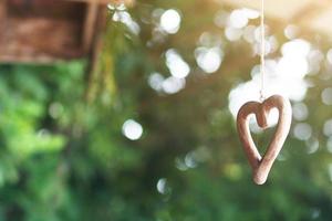 Shape wooden heart hanging on ceilng decorate in wedding ceremony. Valentine day Concept photo