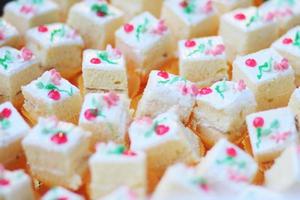 Homemade Square white cake  cream cubes dessert decorated on buffet table photo