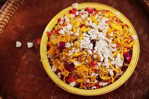 Red rose and Marigold flowers petals in gold tray in tradition Thai wedding ceremony and Buddhism in the temple photo