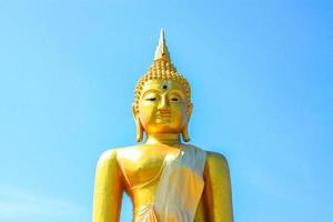 Golden Buddha statue and the old pagoda at ancient temple, Thailand photo