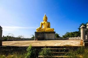 Golden Buddha statue and the old pagoda at ancient temple, Thailand photo