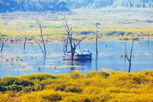 Houseboat in the Songgaria river and near mountain in Countryside of village at Snagklaburi, Thailand photo