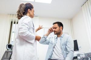 Patient receiving bad news, he is desperate and sad, Doctor support and comforting patient with sympathy. Don't worry, this medical test is not so bad photo