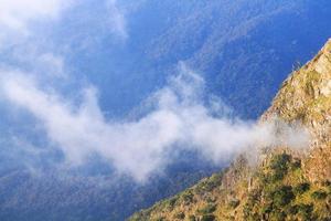 Sunrise in morning with sky and cloud on the Limestone mountain. Sunray with Fog and mist cover the jungle hill in Thailand photo