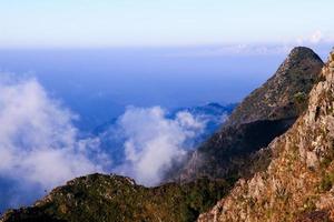 Sunrise in morning with sky and cloud on the mountain. Sunray with Fog and mist cover the jungle hill in Thailand photo