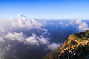 Sunrise in morning with sky and cloud on the mountain. Sunray with Fog and mist cover the jungle hill in Thailand photo