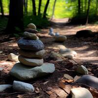 Stones stacked in the forest. stack of stones forming apachetas with forest in the background. space for text. . photo