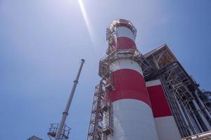 Landscape photo of chimney and stack of combine cycle power plant project. The photo is suitable to use for industry background photography, power plant poster and electricity content media.