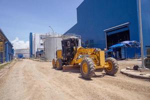 Land scraper and Vibro roller the heavy equipment for pretreatment road construction. The photo is suitable to use for industry background photography, power plant poster and electricity.