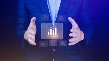 Big data analytics and business intelligence BI concept with chart and graph icons on digital screen interface and business people in the background. photo