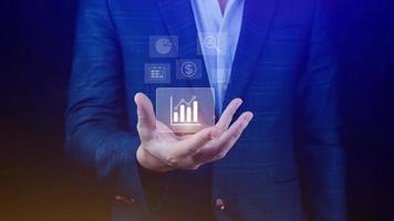 Big data analytics and business intelligence BI concept with chart and graph icons on digital screen interface and business people in the background. photo