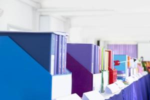 Colorful folders of personnel and office staff are kept and sorted in boxes in the office to evaluate their performance in order to raise their salary or increase their annual remuneration. photo