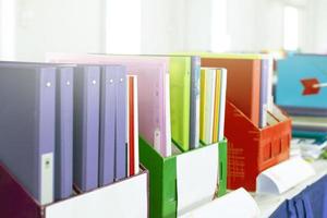 Colorful folders of personnel and office staff are kept and sorted in boxes in the office to evaluate their performance in order to raise their salary or increase their annual remuneration. photo