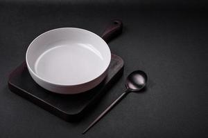 White empty soup bowl on a dark concrete background photo