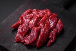 Fresh raw beef with salt, spices and herbs photo