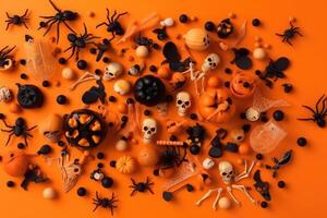 Top view on spooky halloween motifs with bones plastic spiders pumpkins and bats on an orange surface created with technology. photo