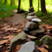 Stones stacked in the forest. stack of stones forming apachetas with forest in the background. space for text. . photo