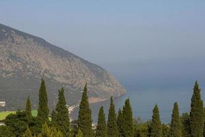 A sea bay surrounded by mountains and sky. A natural landscape. photo