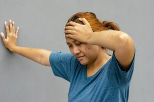 Side view, Asian women touch their temples, feel a headache or dizzy, feeling tired. need painkillers photo