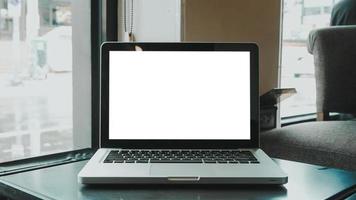 Blank screen laptop computer set up for work on white wooden desk, Mockup, Empty screen, Blank screen for product display. photo