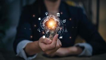 Business global internet connection application technology and digital marketing, finance, and banking, Digital link tech, big data. Hand holding Light bulb Global Internet connection. photo