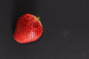 Strawberries on black background photo