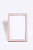 wooden frame with empty space - vertical frame mocap on white background photo