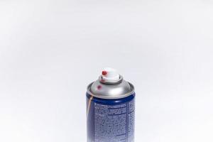 the top of a can of red paint without a cap with traces of use on a white horizontal background. aerosol can mockup photo