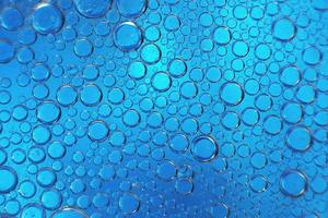 abstract light blue background with oil circles .  bubbles of water close up . oil bubbles in the water macro.  circle bubbles  background photo