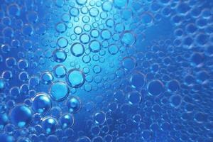 abstract light blue background with oil circles .  bubbles of water close up . oil bubbles in the water macro.  circle bubbles  background photo