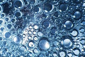 abstract light blue background with oil circles . bubbles of water close up . oil bubbles in the water macro. circle bubbles background photo