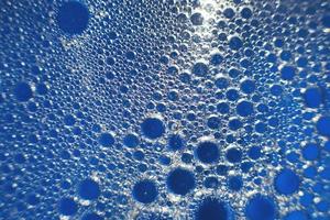 abstract light blue background with oil circles . bubbles of water close up . oil bubbles in the water macro. circle bubbles background photo