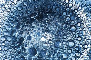 abstract light blue background with oil circles . bubbles of water close up . oil bubbles in the water macro. circle bubbles background photo