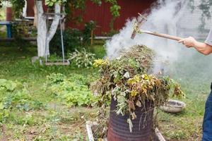 man firing grass in the garden photo