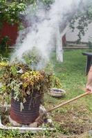 man firing grass in the garden photo