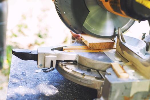 a man is cutting boards with a saw outdoor photo