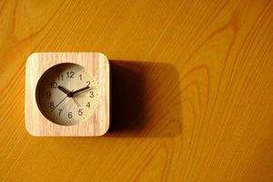 Top View of Wooden Clock on the Table Background. photo