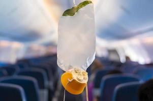 oxygen mask drop from the ceiling compartment on airplane photo