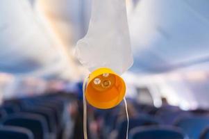 oxygen mask drop from the ceiling compartment on airplane photo