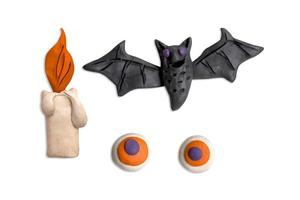 Festive Halloween set of handmade plasticine. Bat, candle and eyes. Plasticine 3d illustration photo