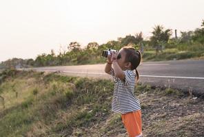 Cute girl looking through binoculars, concept of hiking, camping and adventure. photo