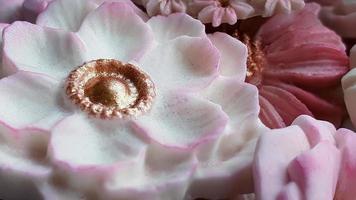 Close up Thai dessert various flower shaped in pastel pink color tone, Coconut milk flavor, Sam Pan Nee traditional Thai handcraft snack, Royal famous Thai sweets, wallpaper photo