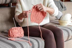 Happy and relaxed female people enjoying time indoor on the sofa. Knit job photo