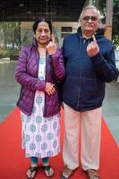 New Delhi, India - March 04 2023 - Unidentified people showing their ink-marked fingers after casting votes in front of polling booth of east Delhi area for MCD local body Elections 2022 photo