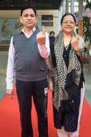 New Delhi, India - March 04 2023 - Unidentified people showing their ink-marked fingers after casting votes in front of polling booth of east Delhi area for MCD local body Elections 2022 photo