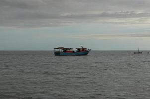 The fisherman's boat is on the sea in the evening photo